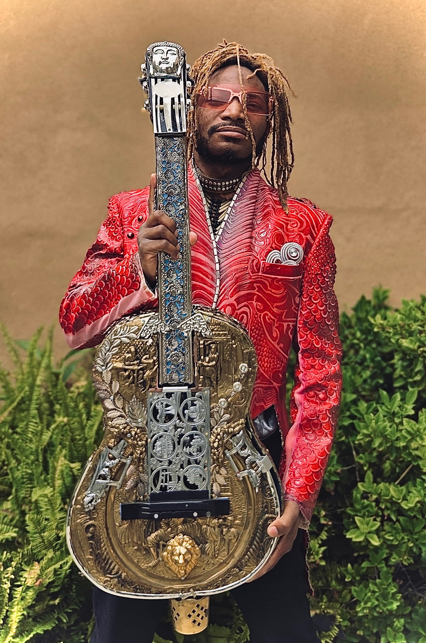 Scooby Trillion holding an ornate guitar